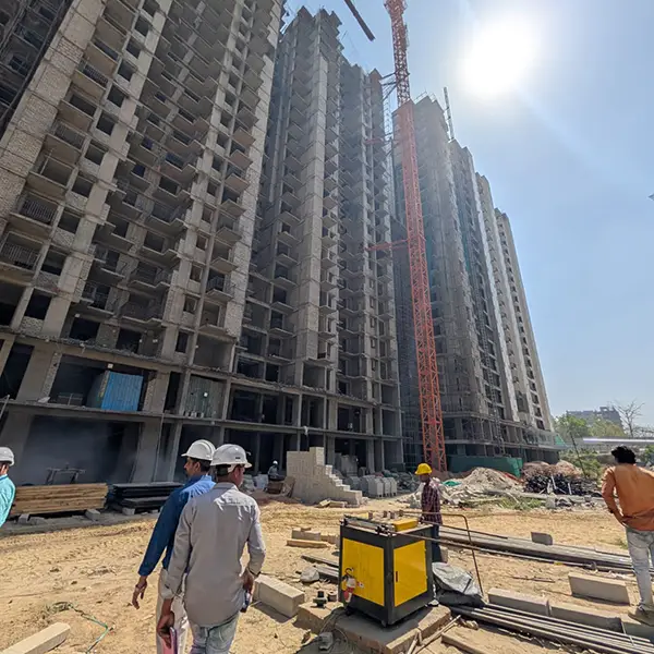 Engineers inspecting high-rise residential construction site.